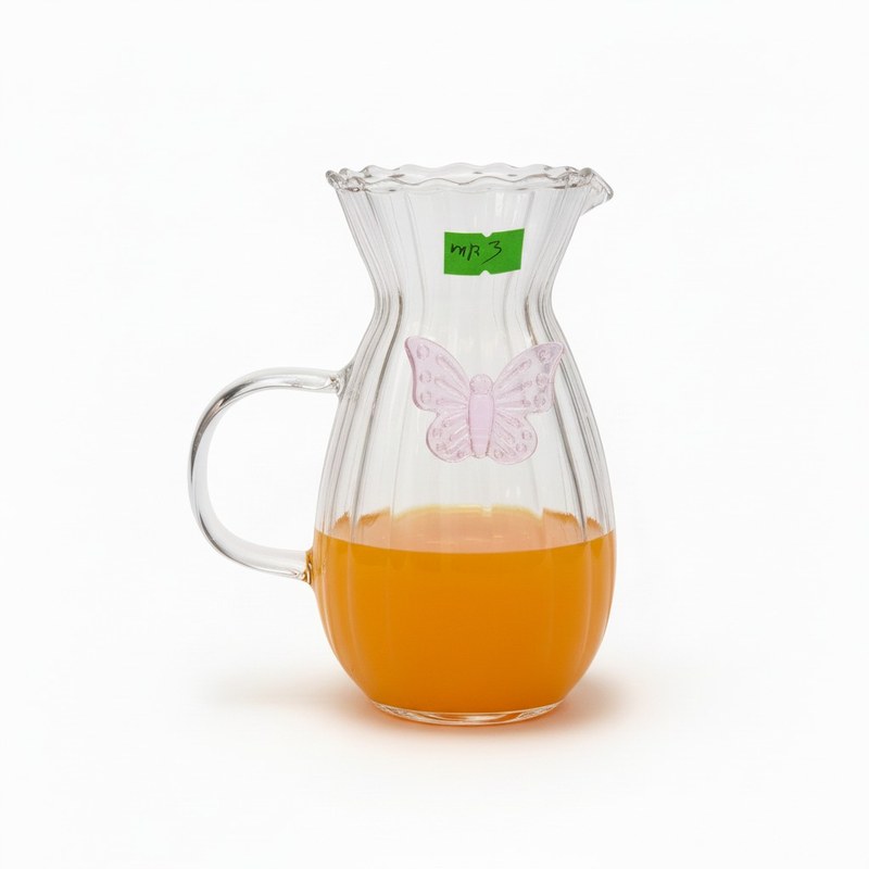 Durable heat-resistant borosilicate glass carafe with embossed butterfly motif ribbed texture and scalloped opening suitable for hot or cold drinks including herbal teas fresh juic